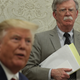 U.S. President Donald Trump speaks to members of the media as National Security Adviser John Bolton listens during a meeting with President of Romania Klaus Iohannis in the Oval Office of the White House August 20, 2019 in Washington, DC.